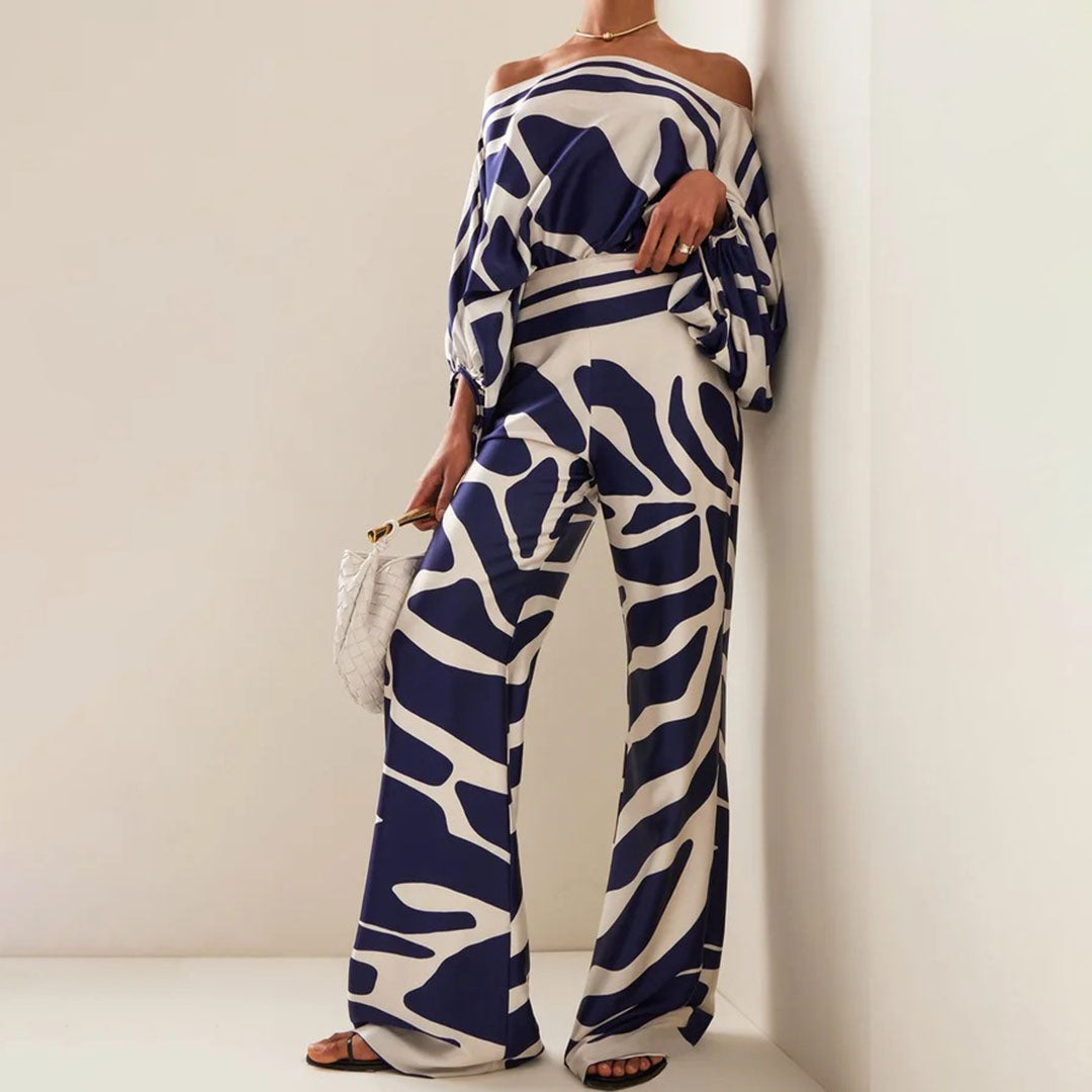 "Ensemble fuchsia à épaules dénudées avec pantalon ample, élégance moderne pour femme, style chic et motifs distincts."