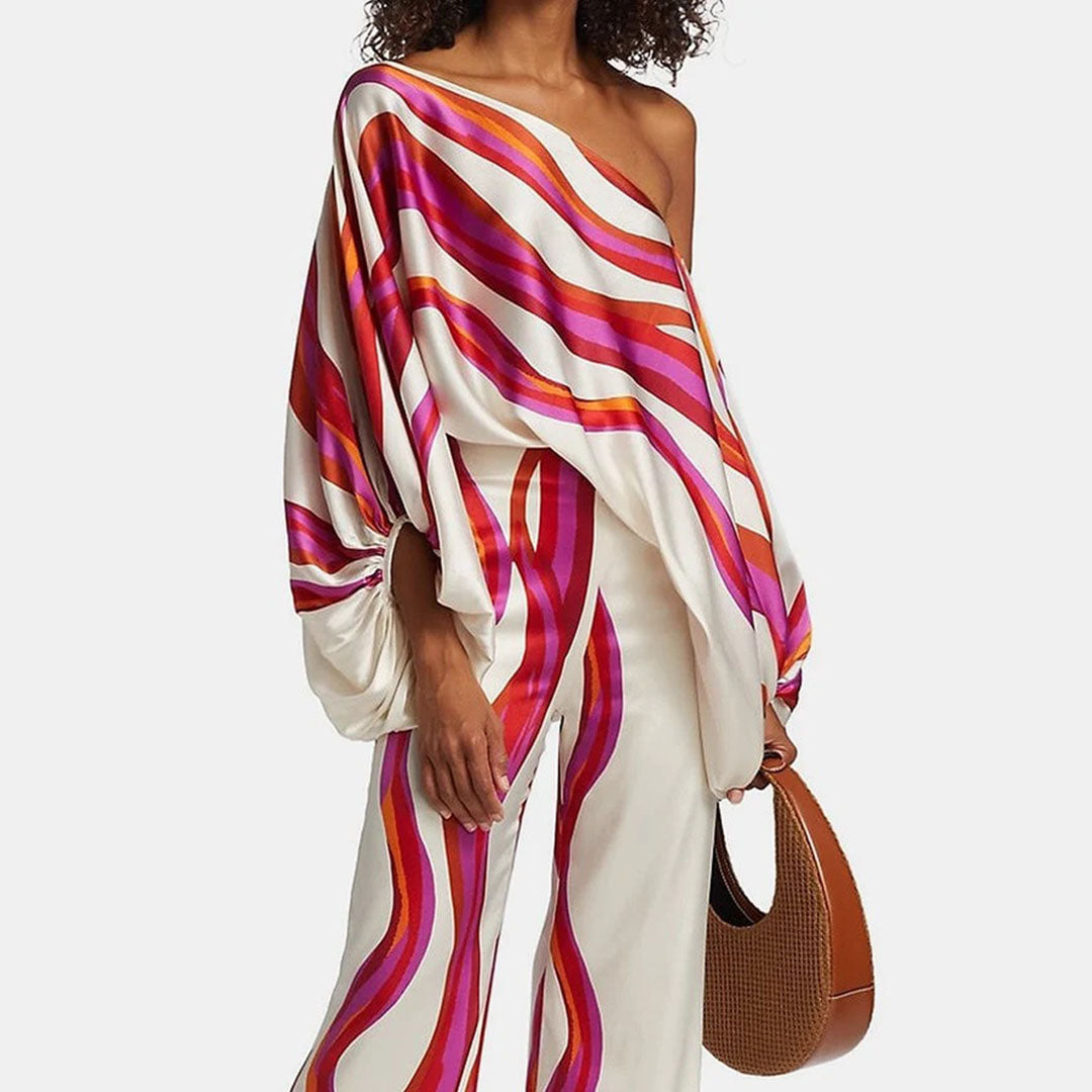 "Ensemble fuchsia à épaules dénudées avec pantalon ample, élégance moderne pour femme, style chic et motifs distincts."