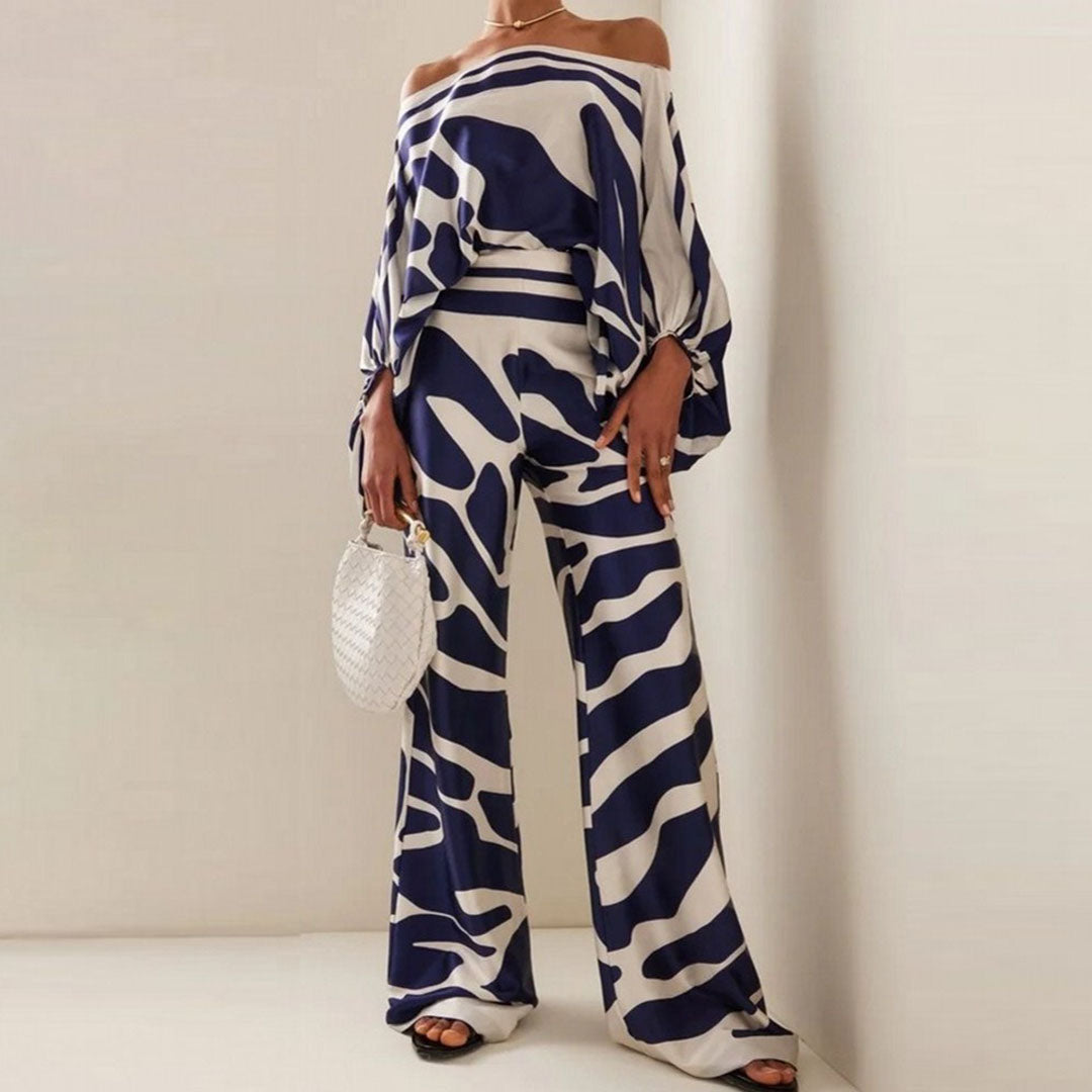 "Ensemble fuchsia à épaules dénudées avec pantalon ample, élégance moderne pour femme, style chic et motifs distincts."