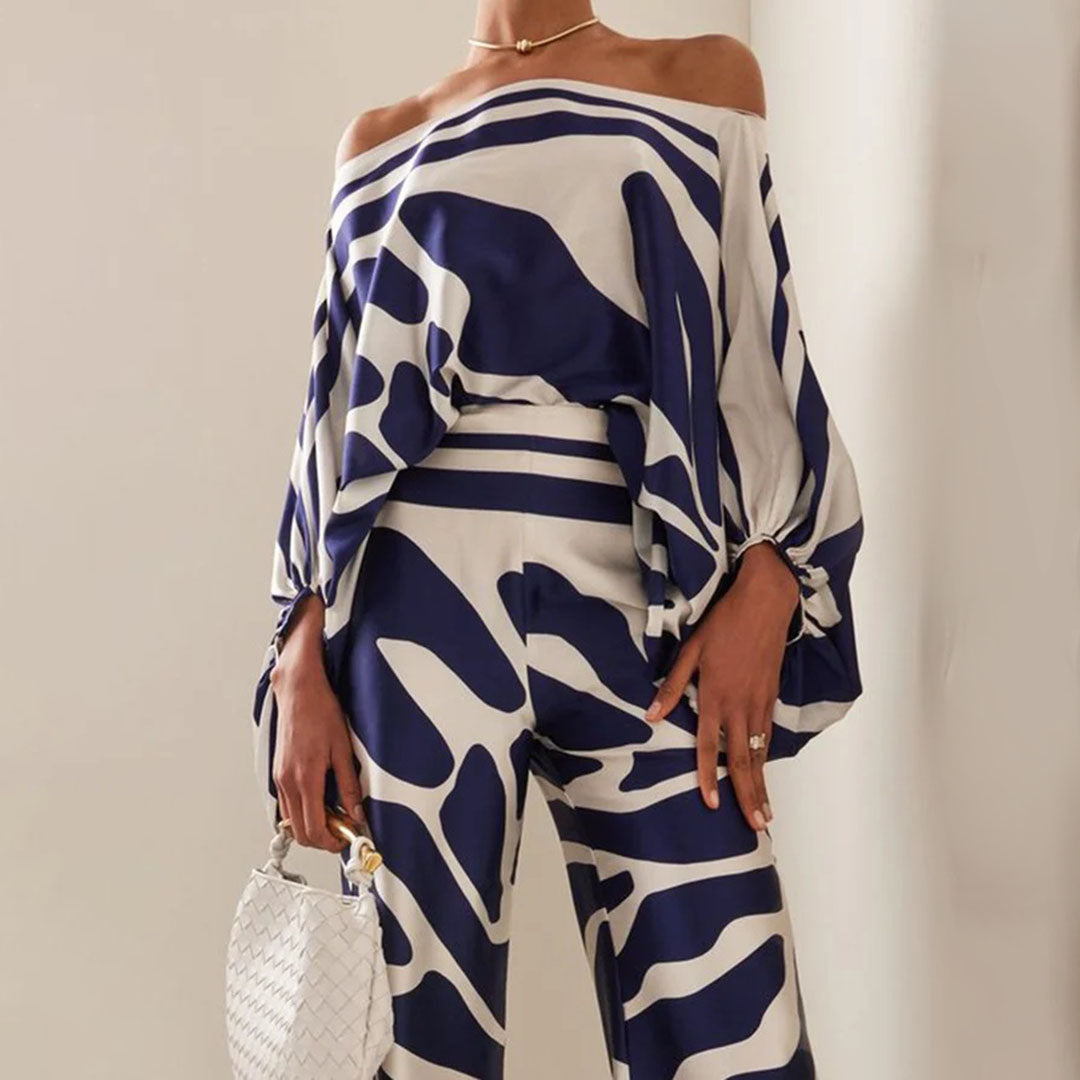 "Ensemble fuchsia à épaules dénudées avec pantalon ample, élégance moderne pour femme, style chic et motifs distincts."