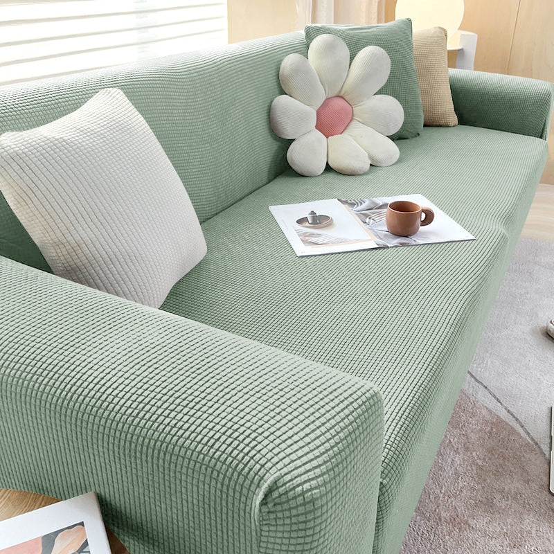 "Housse de canapé élastique beige chic, ajustement impeccable, protège et embellit divers styles de canapés."