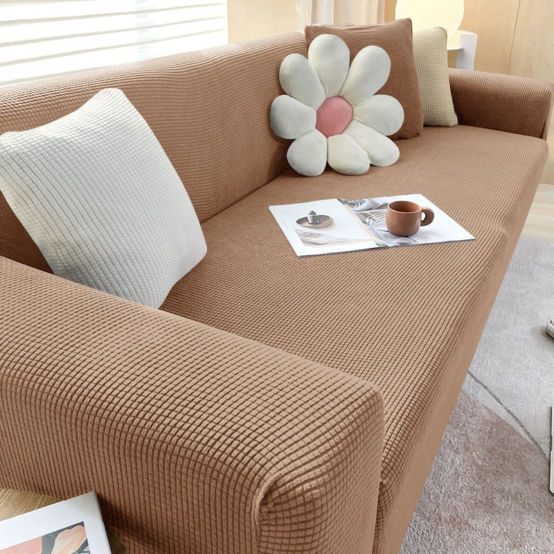 "Housse de canapé élastique beige chic, ajustement impeccable, protège et embellit divers styles de canapés."