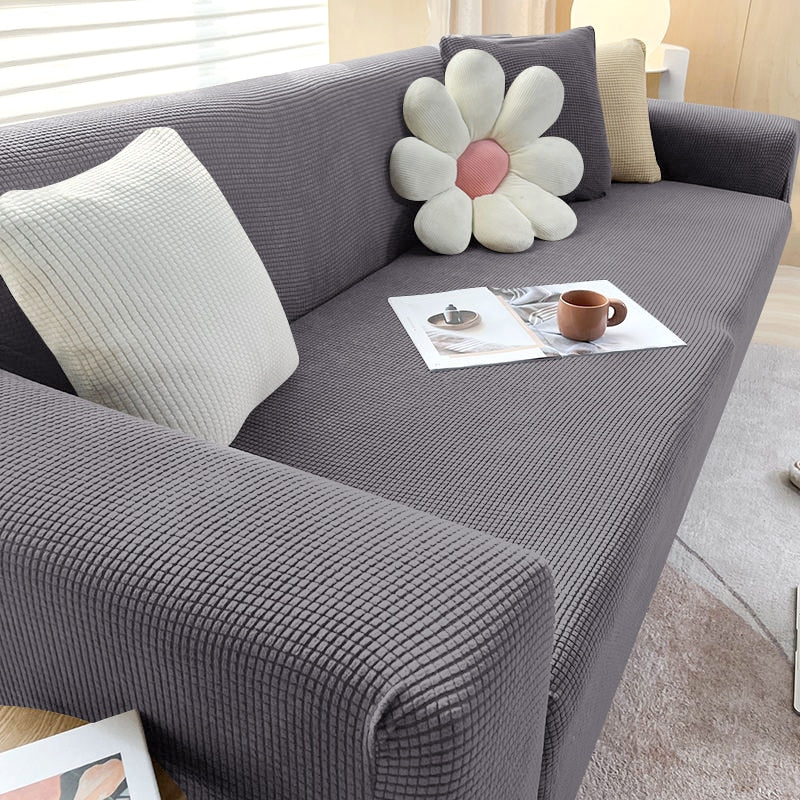"Housse de canapé élastique beige chic, ajustement impeccable, protège et embellit divers styles de canapés."