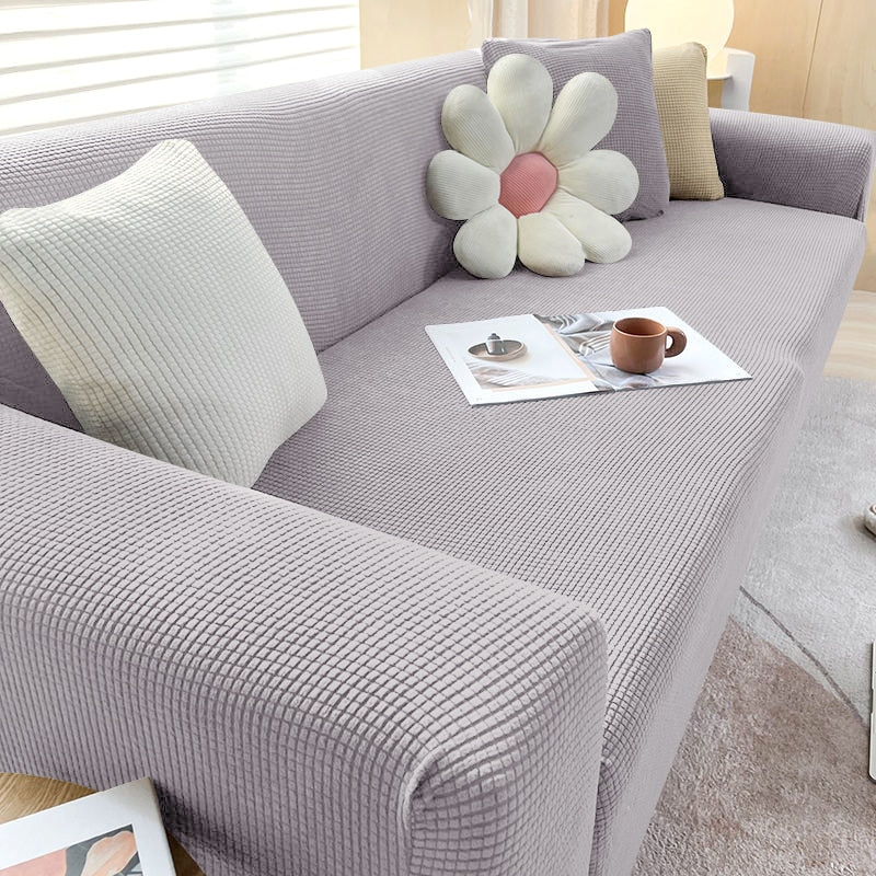"Housse de canapé élastique beige chic, ajustement impeccable, protège et embellit divers styles de canapés."