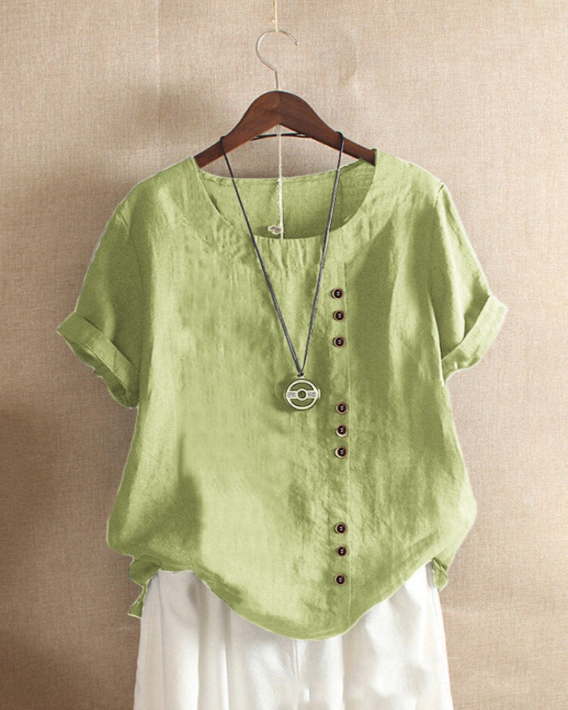 Blouse chic à manches courtes, col rond, en coton doux. Élégante et confortable, idéale pour toutes les occasions.