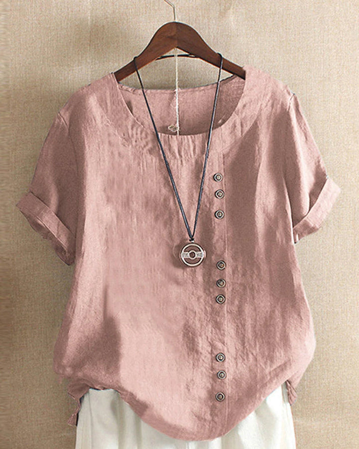 Blouse chic à manches courtes, col rond, en coton doux. Élégante et confortable, idéale pour toutes les occasions.