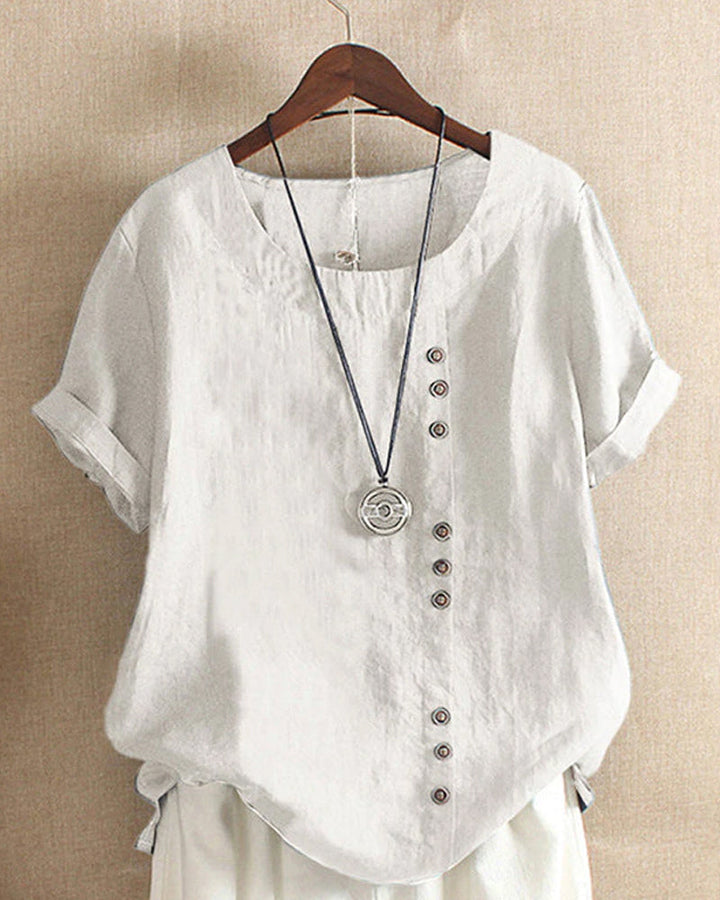 Blouse chic à manches courtes, col rond, en coton doux. Élégante et confortable, idéale pour toutes les occasions.