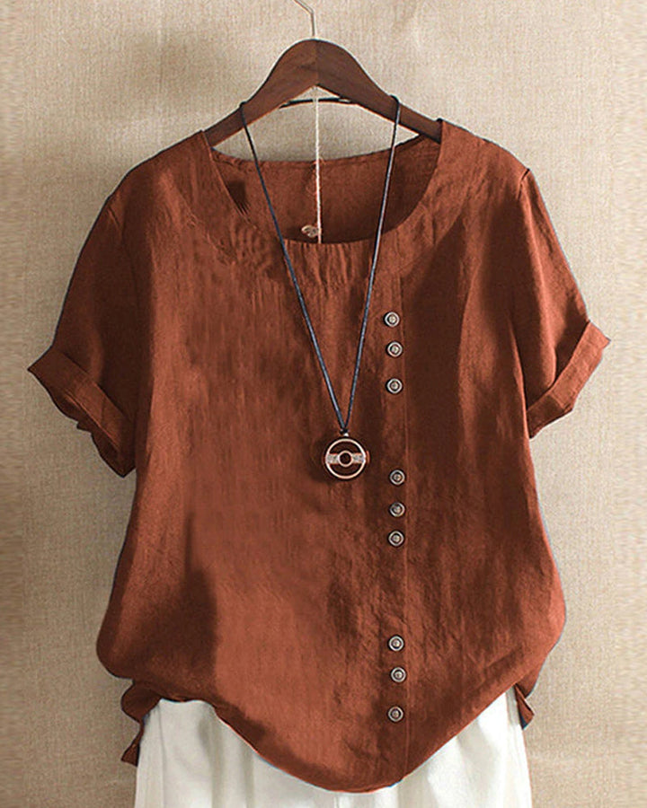 Blouse chic à manches courtes, col rond, en coton doux. Élégante et confortable, idéale pour toutes les occasions.