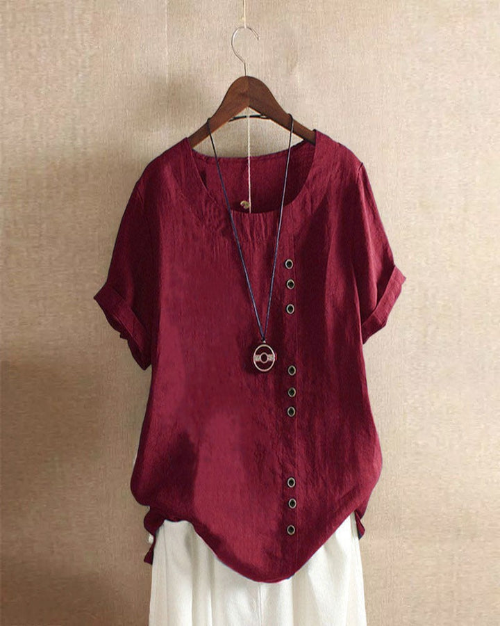Blouse chic à manches courtes, col rond, en coton doux. Élégante et confortable, idéale pour toutes les occasions.