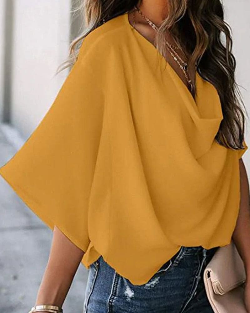 Blouse élégante avec manches chauve-souris, tissu fluide et ample, disponible en plusieurs couleurs, idéale pour femmes.
