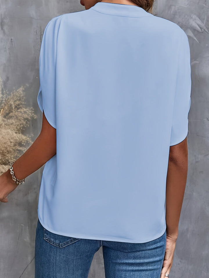 Blouse élégante femme chic en tissu satiné, col orné, couleurs variées, coupe ajustée, style sophistiqué et confortable.