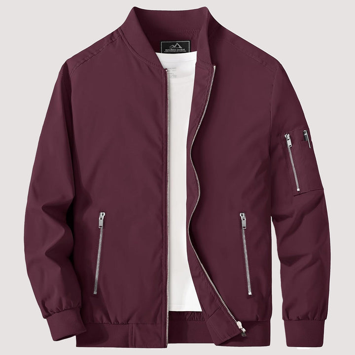 "Blouson bomber léger homme printanier, fermeture éclair, coupe moderne, tissu respirant, couleur bleu royal vibrant."