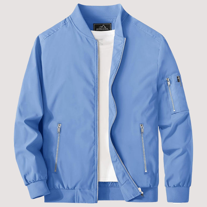 "Blouson bomber léger homme printanier, fermeture éclair, coupe moderne, tissu respirant, couleur bleu royal vibrant."