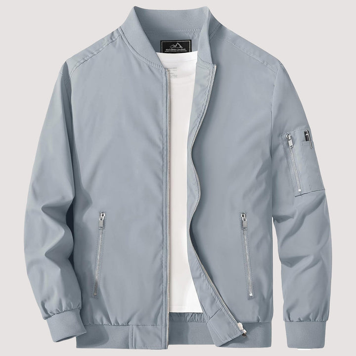 "Blouson bomber léger homme printanier, fermeture éclair, coupe moderne, tissu respirant, couleur bleu royal vibrant."