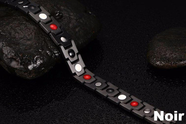 "Bracelet magnétique élégant en noir et argent, avec pierres ocre, offrant équilibre énergétique et bienfaits thérapeutiques.