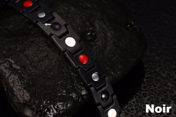 "Bracelet magnétique élégant en noir et argent, avec pierres ocre, offrant équilibre énergétique et bienfaits thérapeutiques.