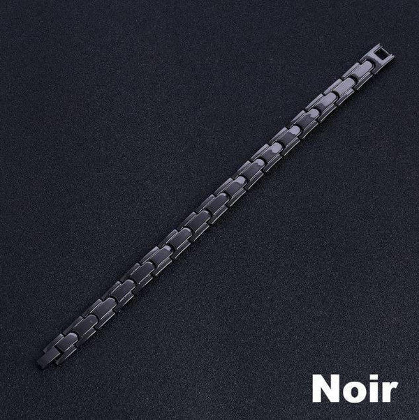 "Bracelet magnétique élégant en noir et argent, avec pierres ocre, offrant équilibre énergétique et bienfaits thérapeutiques.