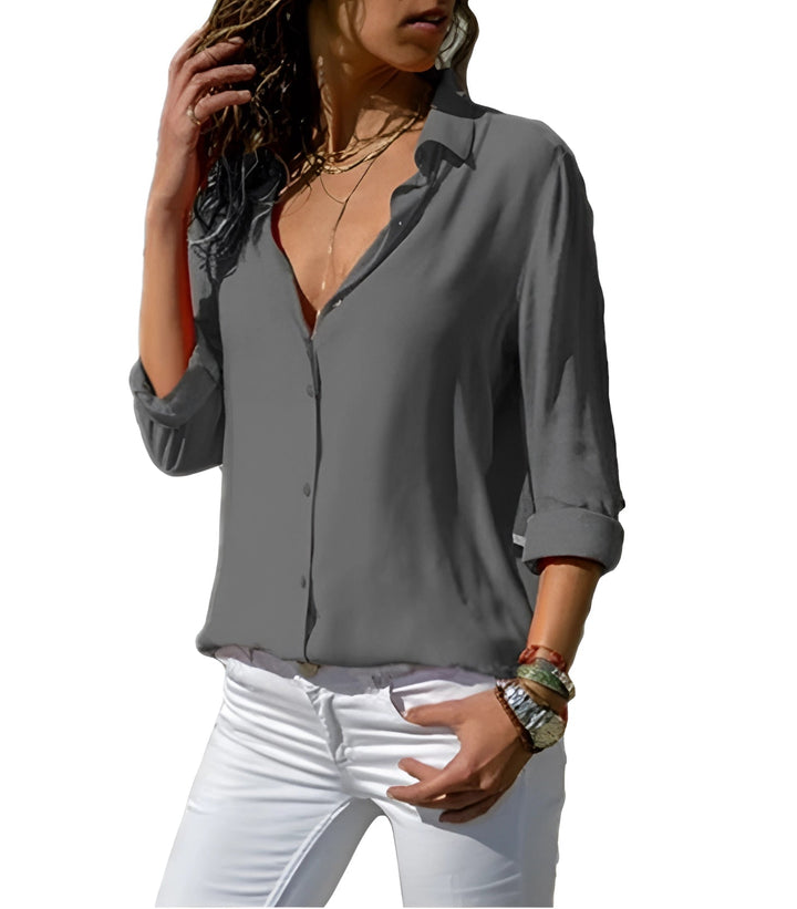 Chemisier en soie orange vif à manches longues, décolleté en V, élégant et confortable, idéal pour occasions spéciales.