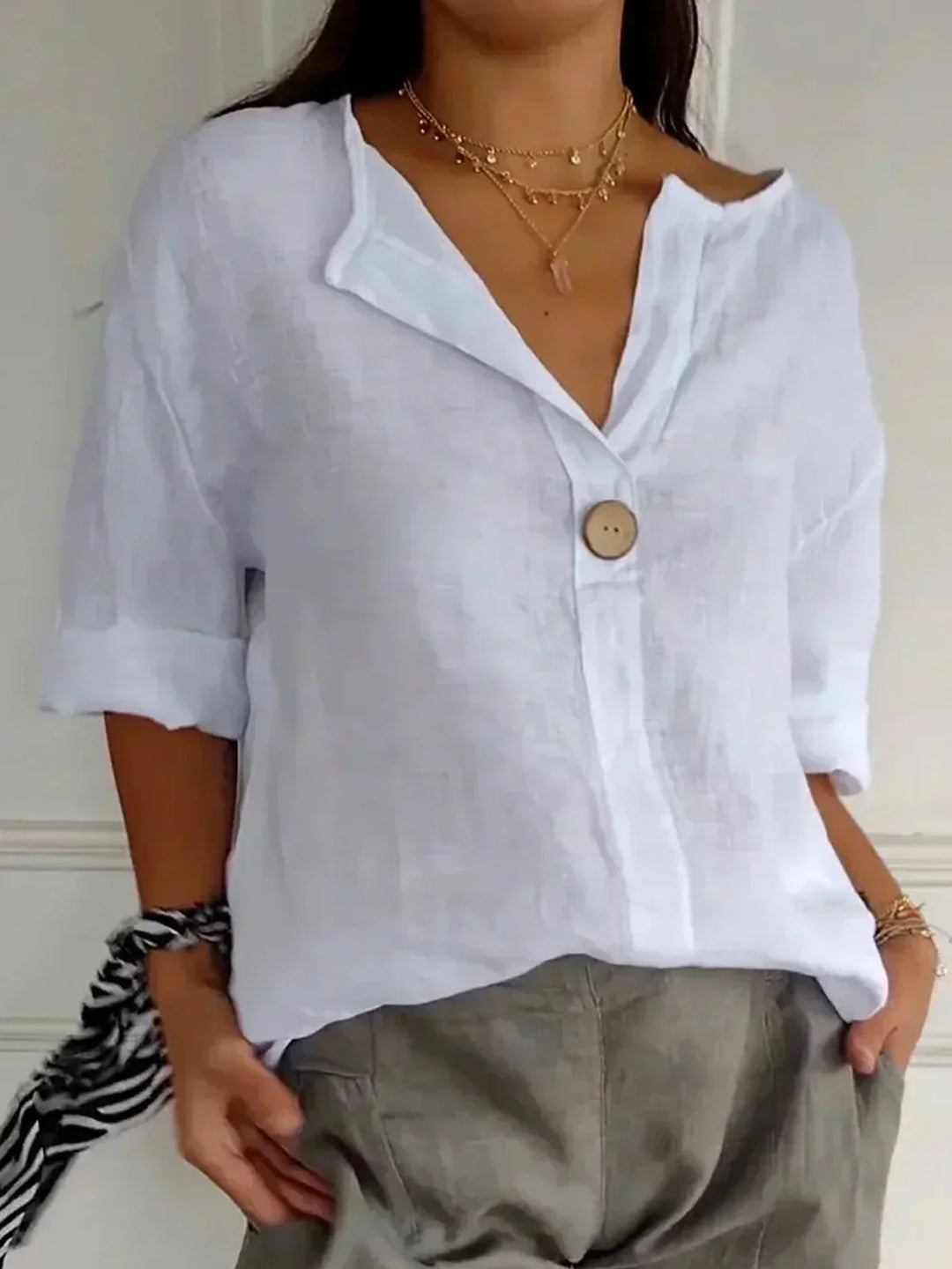"Chemisier femme élégant en lin, col V, coupe ample, blanc, style minimaliste chic et polyvalent."