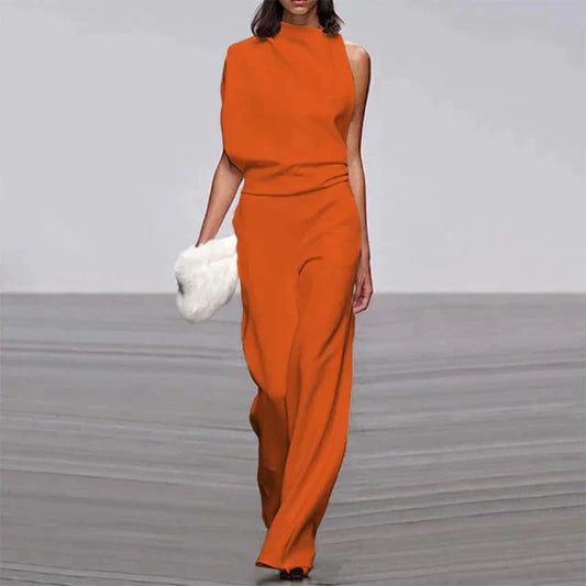 "Combinaison femme élégante sans manches, pantalon ample, tissu léger, disponible en couleurs vives, look sophistiqué."