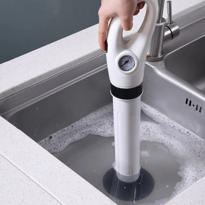 "Déboucheur pneumatique haute efficacité, compact, blanc, avec accessoires, idéal pour les canalisations bouchées."