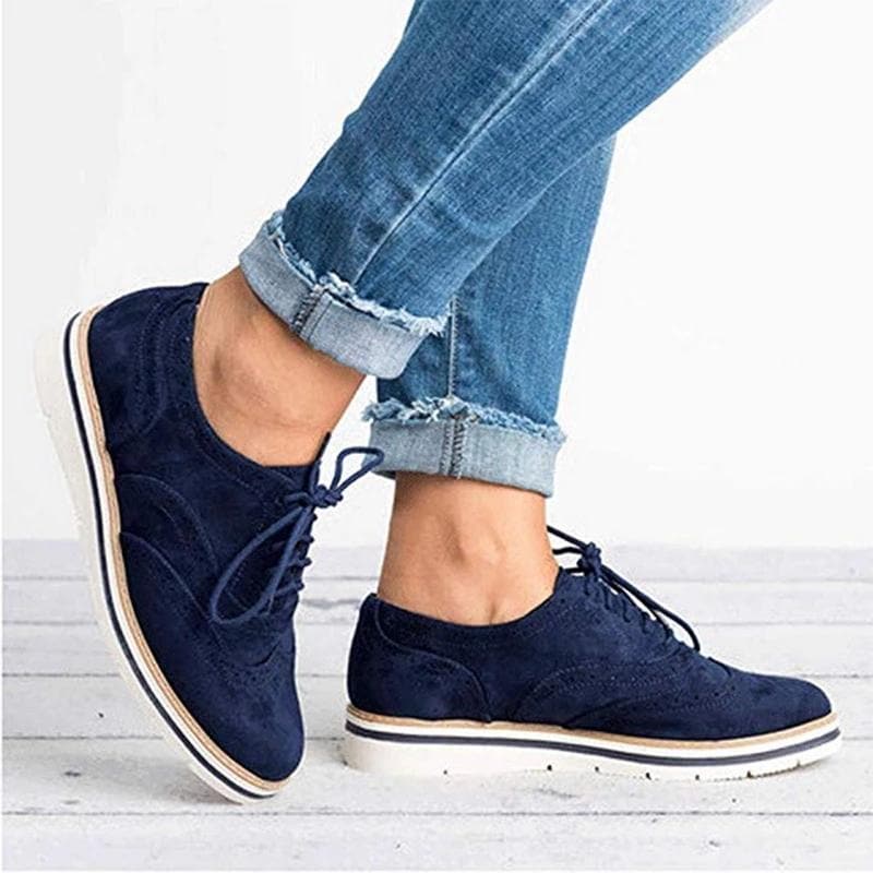 Derby femme en cuir velours, détails brogue, couleur élégante, lacets classiques, idéale pour un style raffiné.