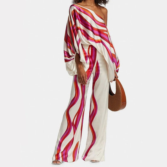 "Ensemble fuchsia à épaules dénudées avec pantalon ample, élégance moderne pour femme, style chic et motifs distincts."