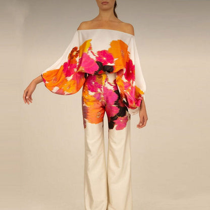 "Ensemble fuchsia à épaules dénudées avec pantalon ample, élégance moderne pour femme, style chic et motifs distincts."