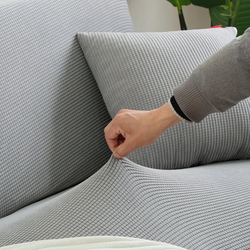 "Housse de canapé élastique beige chic, ajustement impeccable, protège et embellit divers styles de canapés."