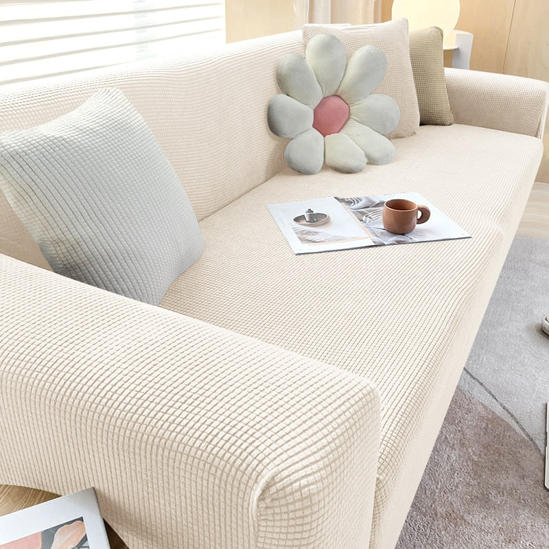 "Housse de canapé élastique beige chic, ajustement impeccable, protège et embellit divers styles de canapés."