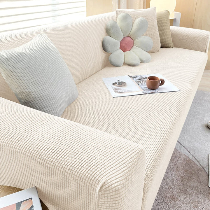 "Housse de canapé élastique beige chic, ajustement impeccable, protège et embellit divers styles de canapés."