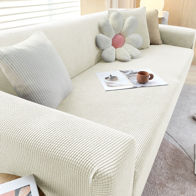Housse de canapé extensible beige avec motif élégant et design antidérapant, disponible en plusieurs tailles pour salons mode