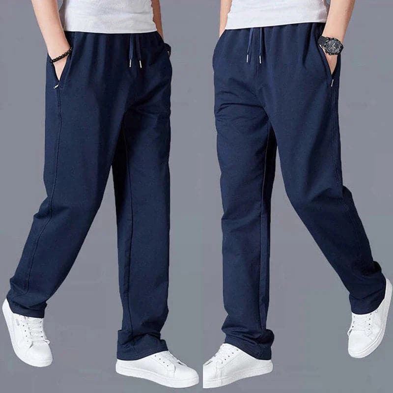 "Joggers noirs pour homme, style urbain et décontracté, avec coupe fuselée et poches zippées pratiques."