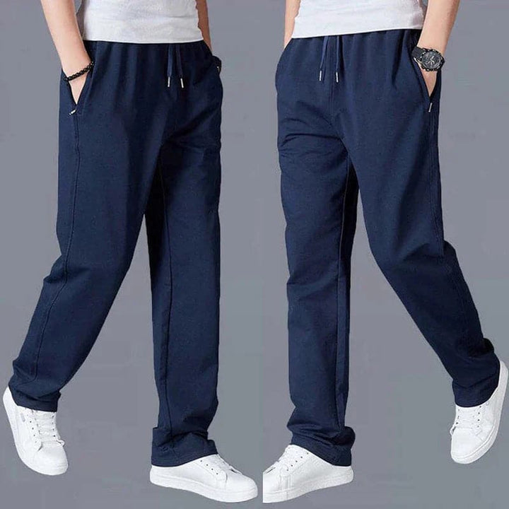 "Joggers noirs pour homme, style urbain et décontracté, avec coupe fuselée et poches zippées pratiques."