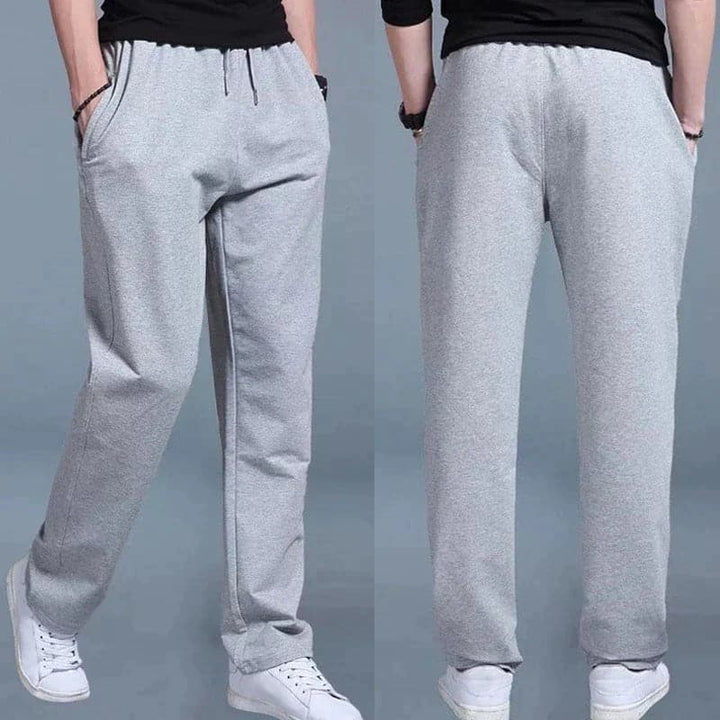 "Joggers noirs pour homme, style urbain et décontracté, avec coupe fuselée et poches zippées pratiques."