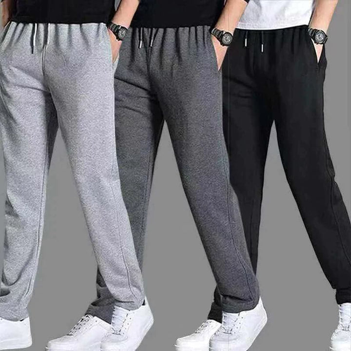 "Joggers noirs pour homme, style urbain et décontracté, avec coupe fuselée et poches zippées pratiques."