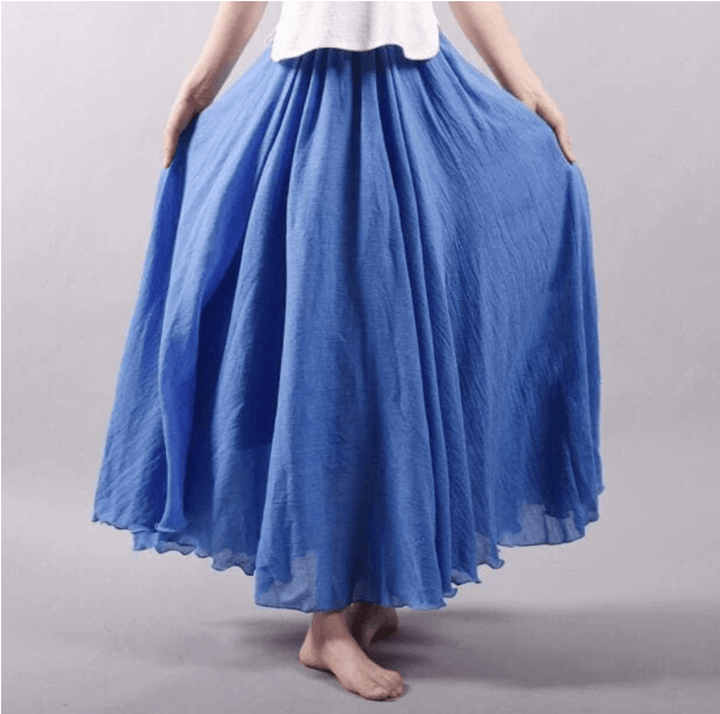 "Jupe longue bohème en lin beige, coupe fluide, taille élastique, parfaite pour un style estival élégant et confortable."