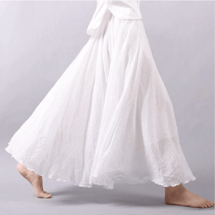 "Jupe longue bohème en lin beige, coupe fluide, taille élastique, parfaite pour un style estival élégant et confortable."