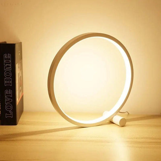 "Lampe de table LED tactile moderne au design circulaire, minimaliste, offrant un éclairage élégant."