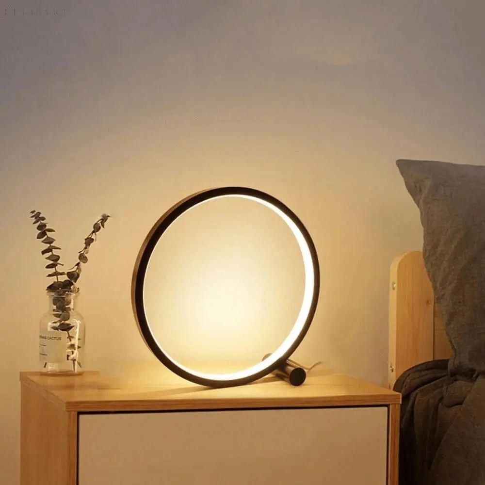 "Lampe de table LED tactile moderne au design circulaire, minimaliste, offrant un éclairage élégant."