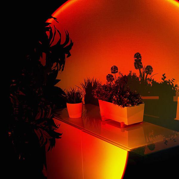 "Lampe LED ambiance soleil, multicolore, projette teintes chaudes; tête réglable 180°, diverses lentilles interchangeables."