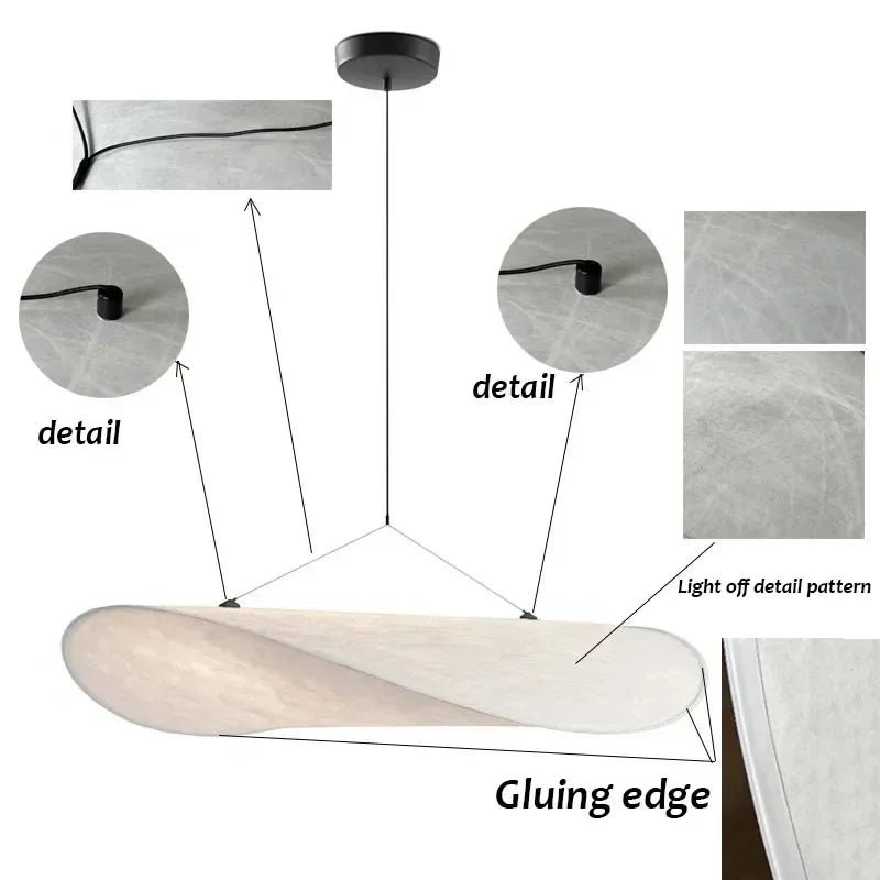 Lampe suspendue design en soie, formes fluides et élégantes, créant une lumière douce pour un intérieur chic et apaisant.