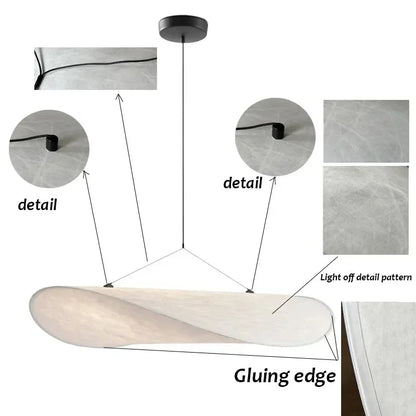 Lampe suspendue design en soie, formes fluides et élégantes, créant une lumière douce pour un intérieur chic et apaisant.