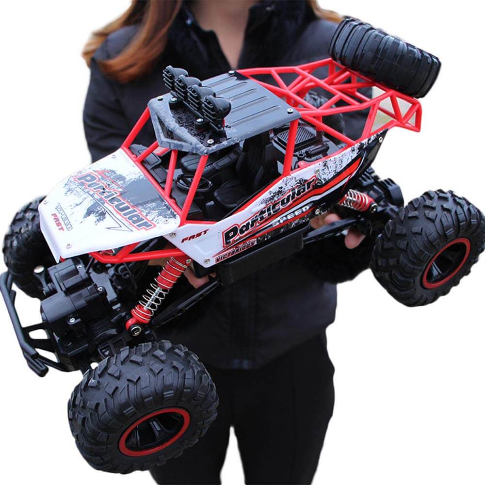 "Monster Truck RC 4x4 rouge sur terrain rocailleux, suspension robuste et pneus antidérapants pour aventures extrêmes."