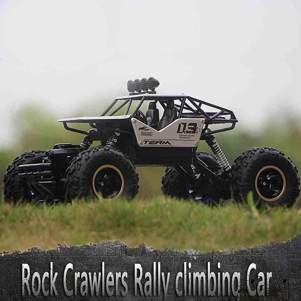 "Monster Truck RC 4x4 rouge sur terrain rocailleux, suspension robuste et pneus antidérapants pour aventures extrêmes."