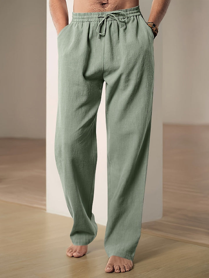 "Pantalon décontracté homme ample, beige avec cordon de serrage et poches, vue de côté, style et confort optimal"