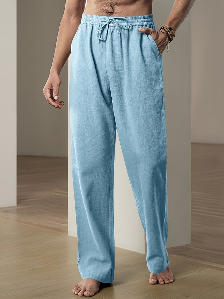 "Pantalon décontracté homme ample, beige avec cordon de serrage et poches, vue de côté, style et confort optimal"