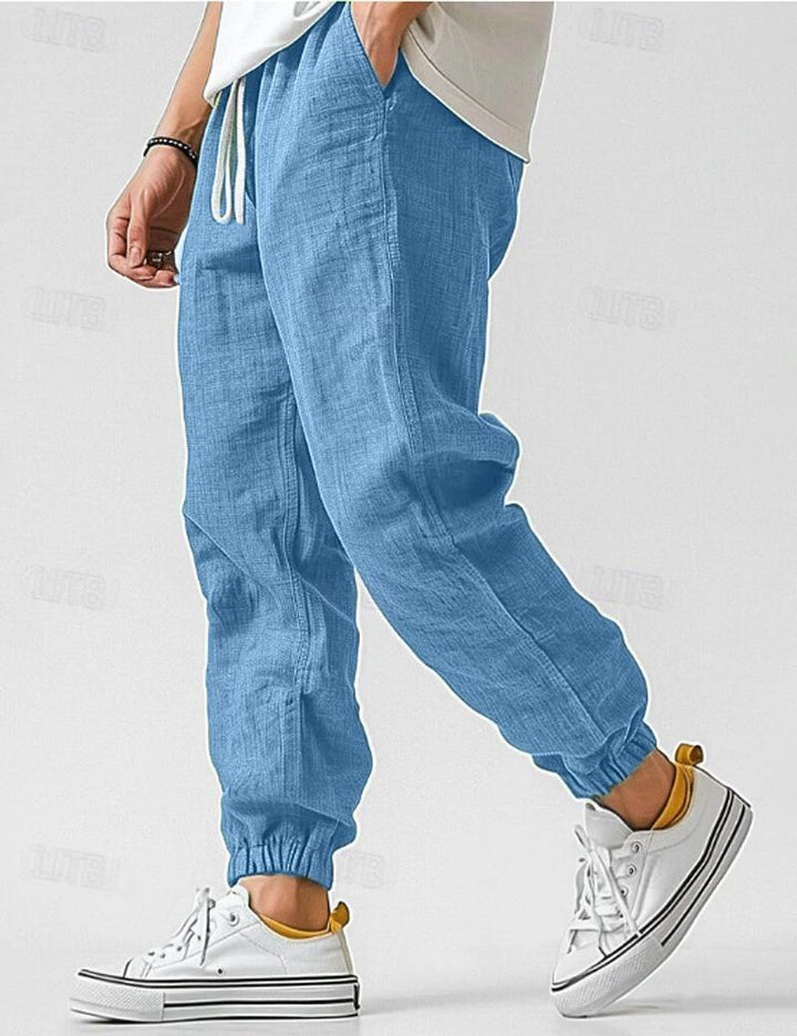 "Pantalon en lin bleu pour hommes, léger et respirant, style décontracté pour l'été, offrant confort et élégance."