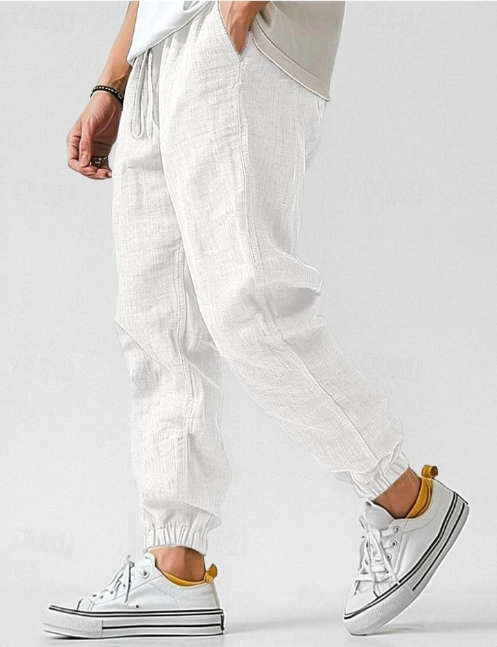"Pantalon en lin bleu pour hommes, léger et respirant, style décontracté pour l'été, offrant confort et élégance."