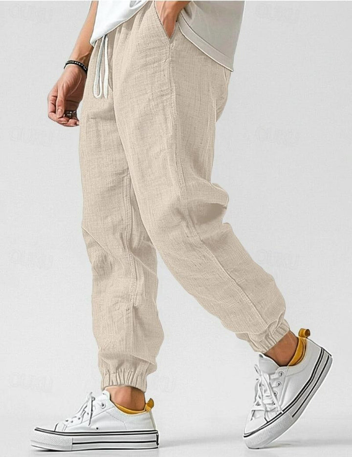 "Pantalon en lin bleu pour hommes, léger et respirant, style décontracté pour l'été, offrant confort et élégance."